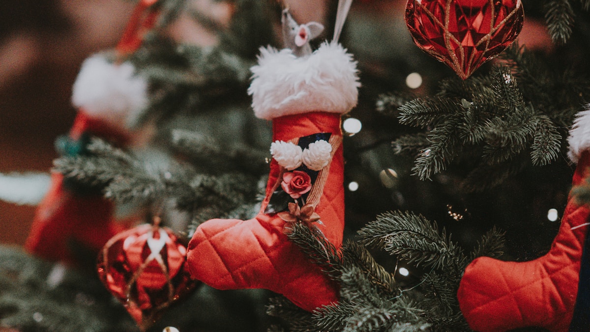 Elegant perfume bottle with holiday decorations and warm candlelight